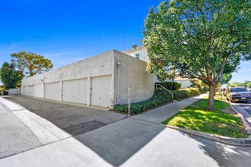 A concrete building with a tree in front of it.