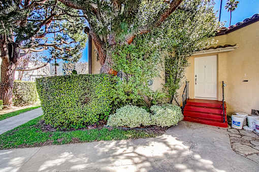 A house with a red staircase leading to the front door.