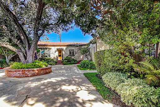 A house with a stone pathway leading to the front door.