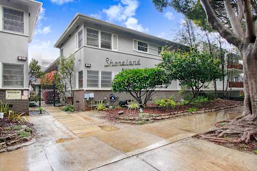 A building with the word "Shorelands" on it is surrounded by greenery.