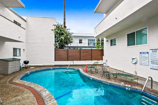 A small residential pool surrounded by a brick border.