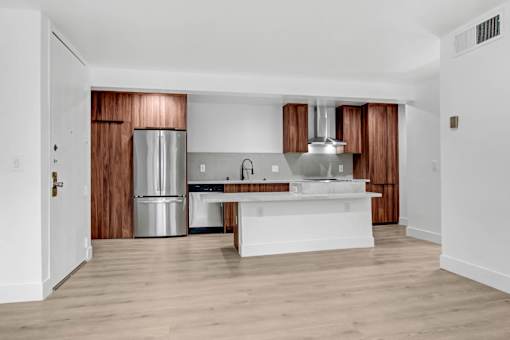 A modern kitchen with wooden cabinets and stainless steel appliances.