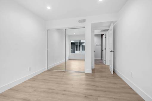 A long hallway with a mirror on the wall.