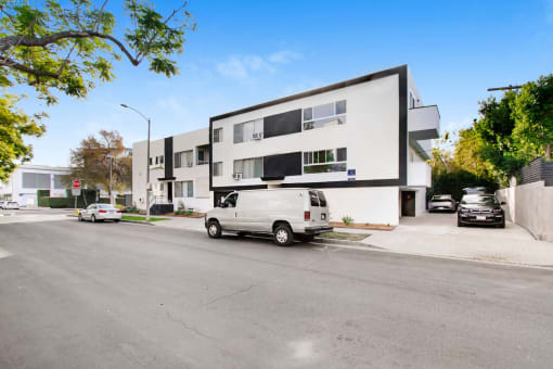 a white van parked in front of a white building