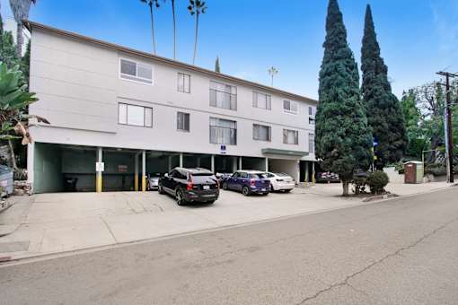 A building with a parking lot in front of it.
