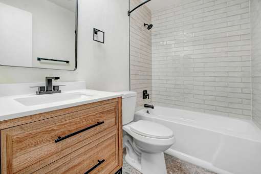 a bathroom with a sink toilet and a bath tub