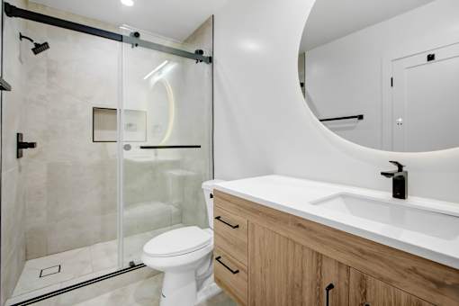 A modern bathroom with a white toilet and a white sink.