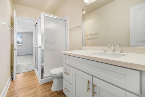 A bathroom with a white toilet and a white sink.