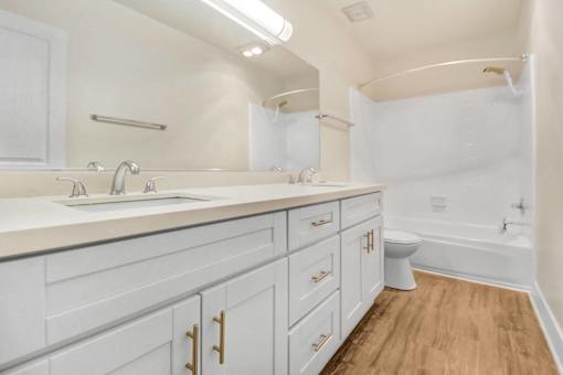 A white bathroom with a toilet in the corner.