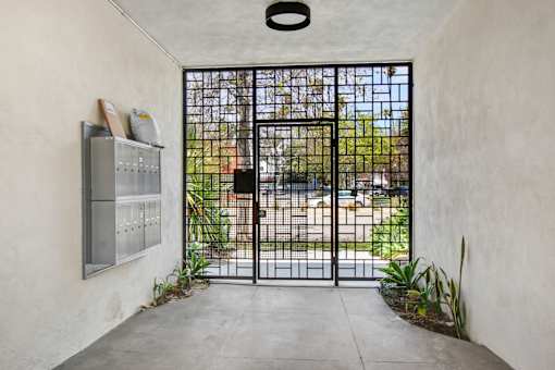 A black gate is closed and locked.