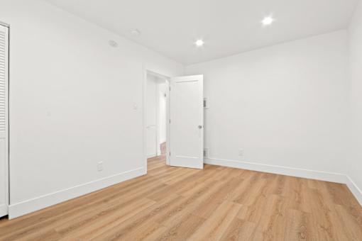 A room with wooden floors and white walls.