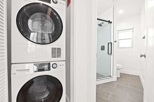 A white washing machine and dryer in a laundry room.