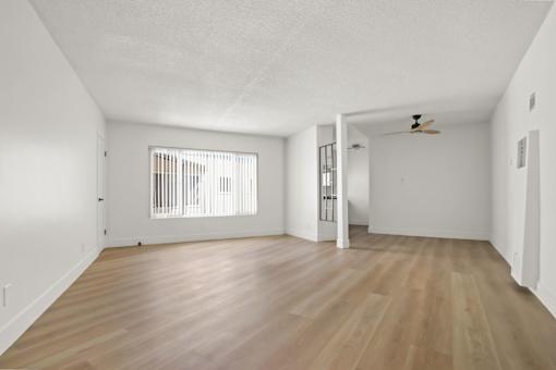A room with wooden floors and a ceiling fan.