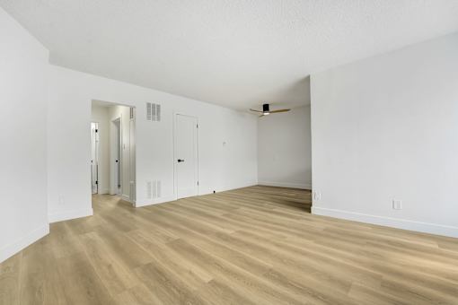 A room with wooden floors and white walls.