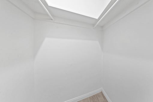 A white room with a skylight.