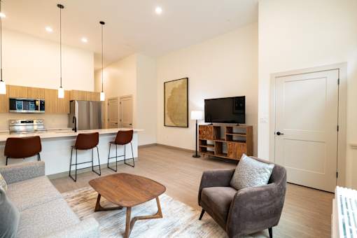 A modern living room with a bar area and a television.