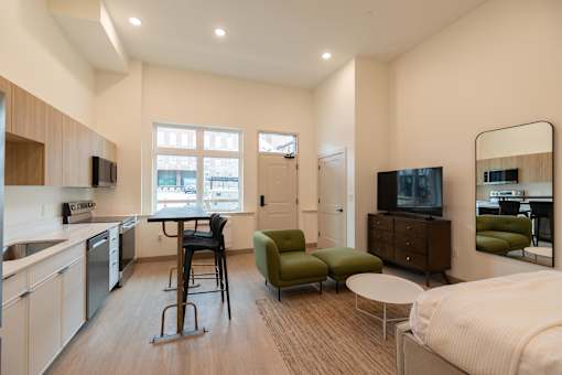 A modern kitchen with a dining table and chairs.
