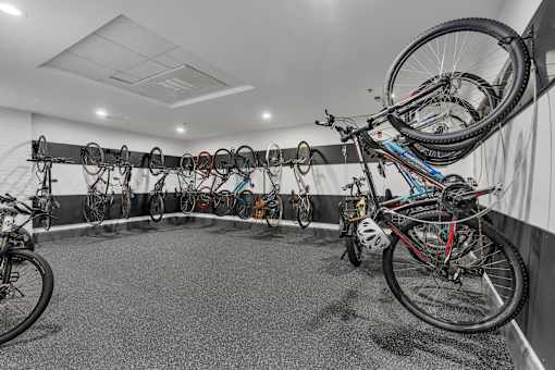 A bike shop with many bikes hanging on the wall.