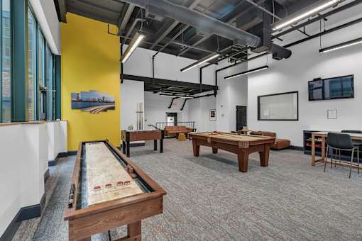 A room with a pool table and a yellow wall.