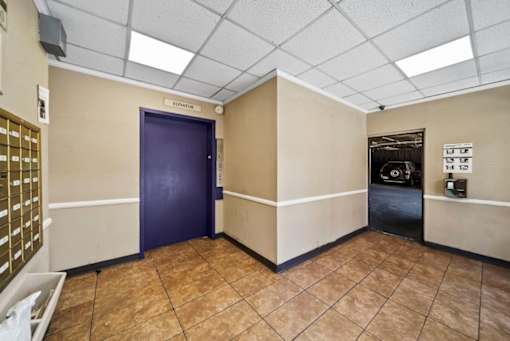A room with a purple door and a sign that says "LIBRARY".