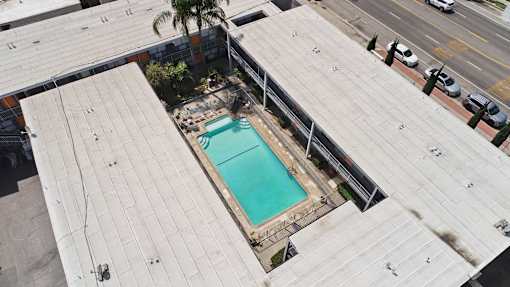 A small pool is surrounded by a concrete patio.