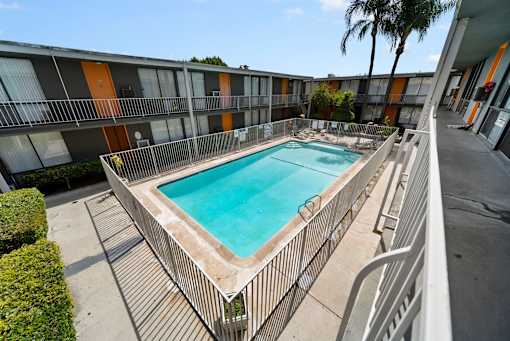 A rectangular pool with a metal fence around it.