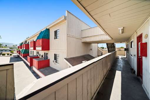 A long building with red and green doors.