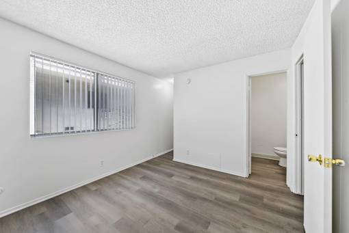 A room with a window and a door.