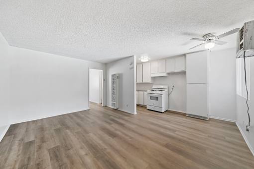 A room with a wood floor and white walls.