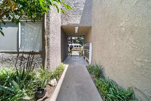 A pathway leads to a gate in a courtyard.