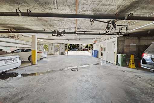 A parking garage with a white car parked on the left side.