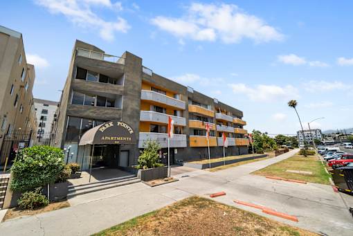A large apartment complex with a sign that says "Apartments" on the front.