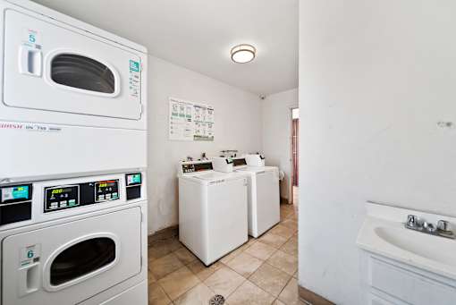 A small laundry room with a washer and dryer.