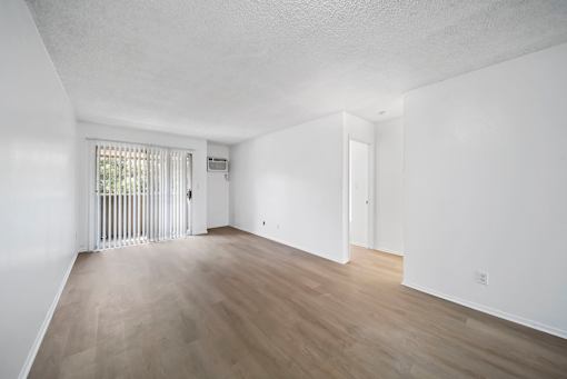 A room with a sliding door and a window with blinds.