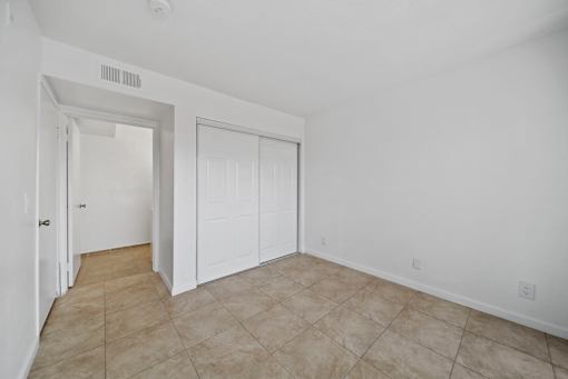 A room with white walls and a tiled floor.