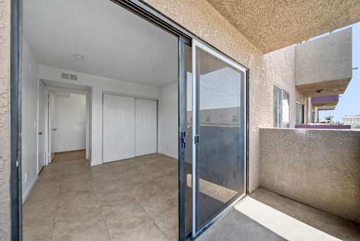 A view of a hallway with a sliding glass door.