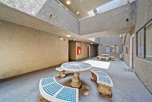 A room with a table and chairs made of blue tiles.