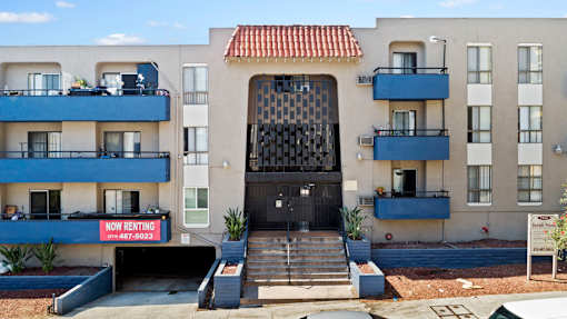 A building with a black gate and a sign that says "NO RENTING" in front of it.