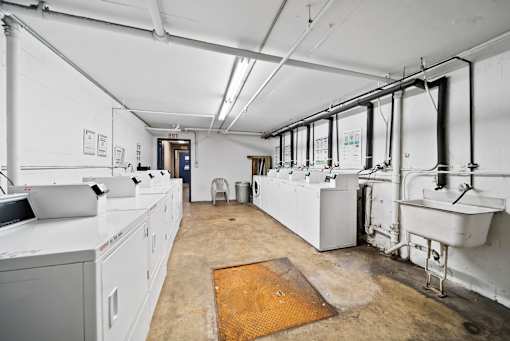 A large industrial room with white walls and a yellow mat on the floor.