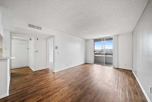 A room with wooden floors and white walls.