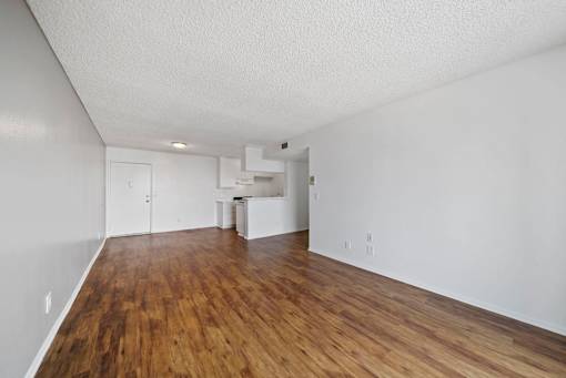 A room with wooden floors and white walls.