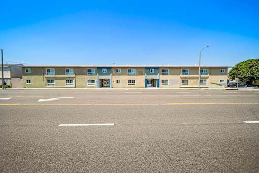 A row of apartment buildings with a clear blue sky above.