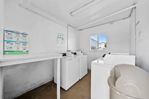 A white laundry room with a washer and dryer.