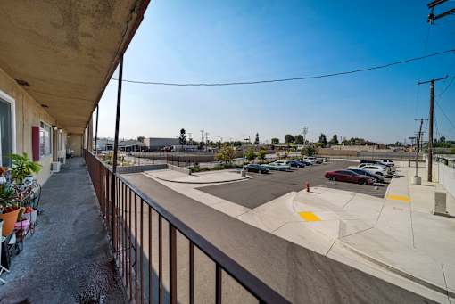 A parking lot with cars and a building in the background.