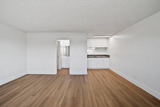 A room with wooden floors and white walls.