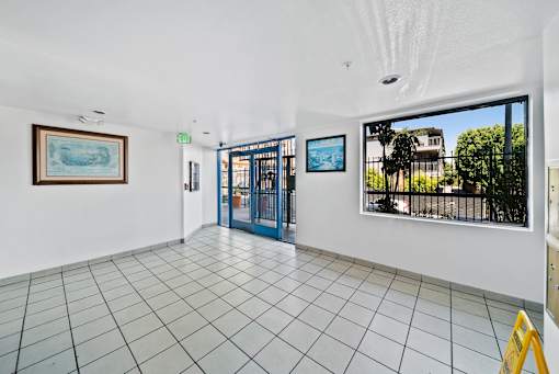 A room with a tiled floor and a painting on the wall.
