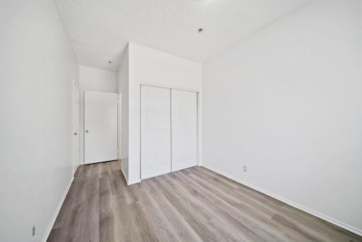 A room with a white door and a white wall.