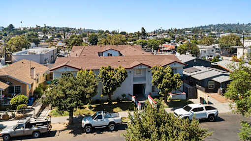 A white truck is parked in front of a house.
