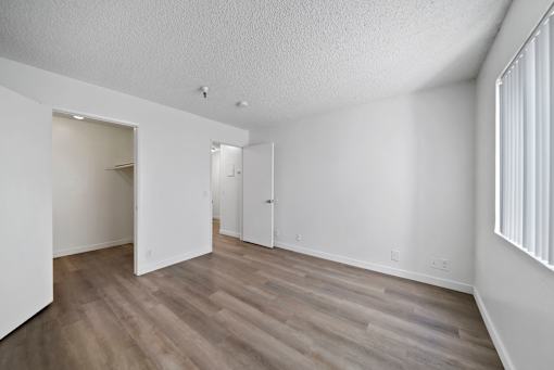 A room with wooden floors and white walls.