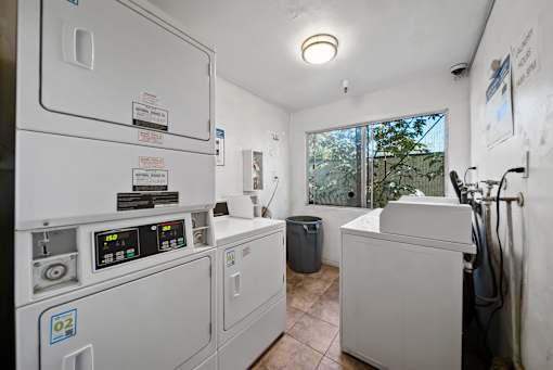 A room with a washing machine and a dryer.
